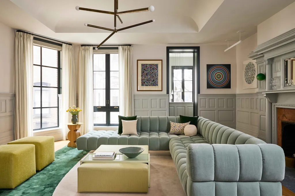 Hotel lounge with tall windows, seating and canvases on the wall