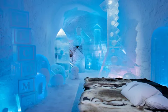 Sleeping chamber with a carved ice wall and a low platform bed